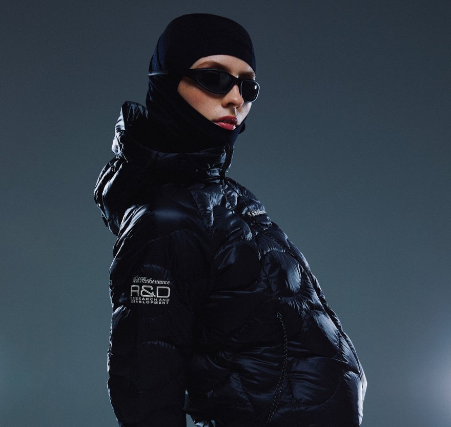 Model in a black Peak Performance 40Y R&D down jacket